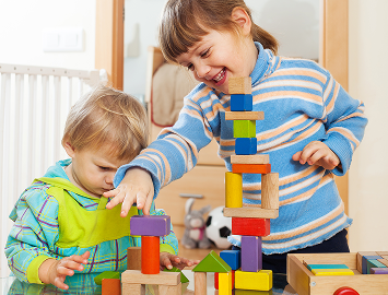 Young children playing with building blocks